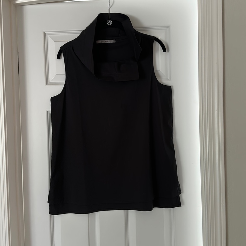 Black sleeveless split neck top. Neck is split at side and can be up or down.